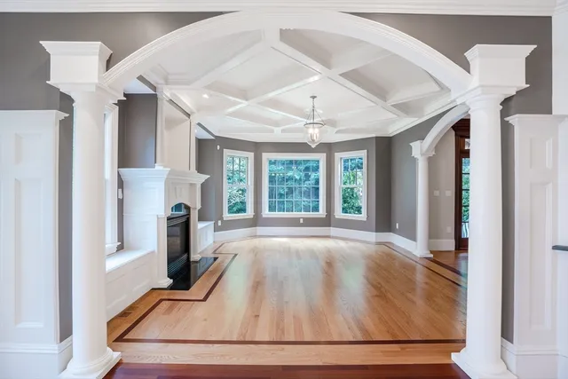 a view of an empty room with a fireplace and a window