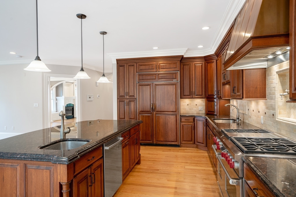 52 North Border Road, Unit 52 Winchester, MA 01890 - Photo 24 of 34 a kitchen with stainless steel appliances granite countertop a sink a stove and a refrigerator