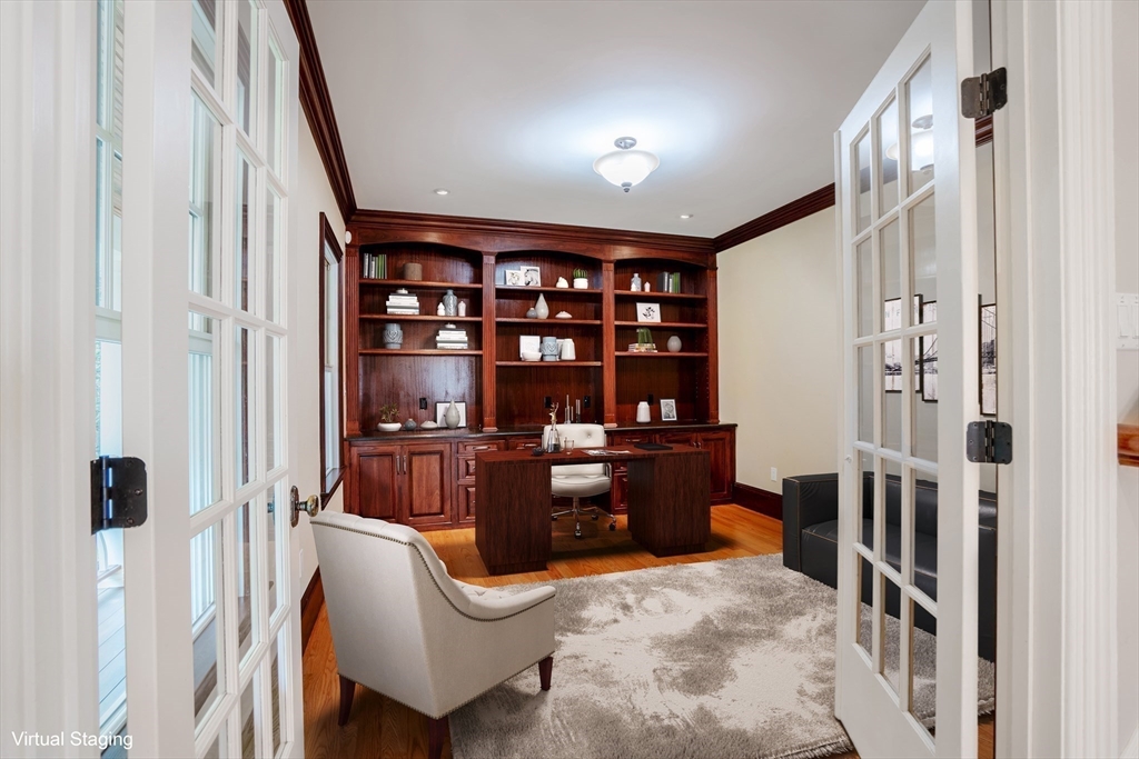 52 North Border Road, Unit 52 Winchester, MA 01890 - Photo 29 of 34 a room with furniture a rug and a book shelf