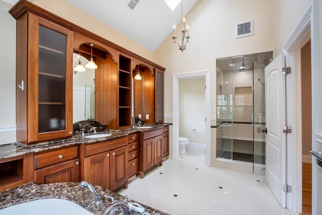 a bathroom with a tub sink and mirror