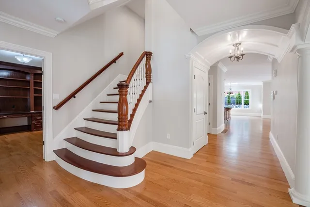 a view of an entryway with wooden floor and a livingroom
