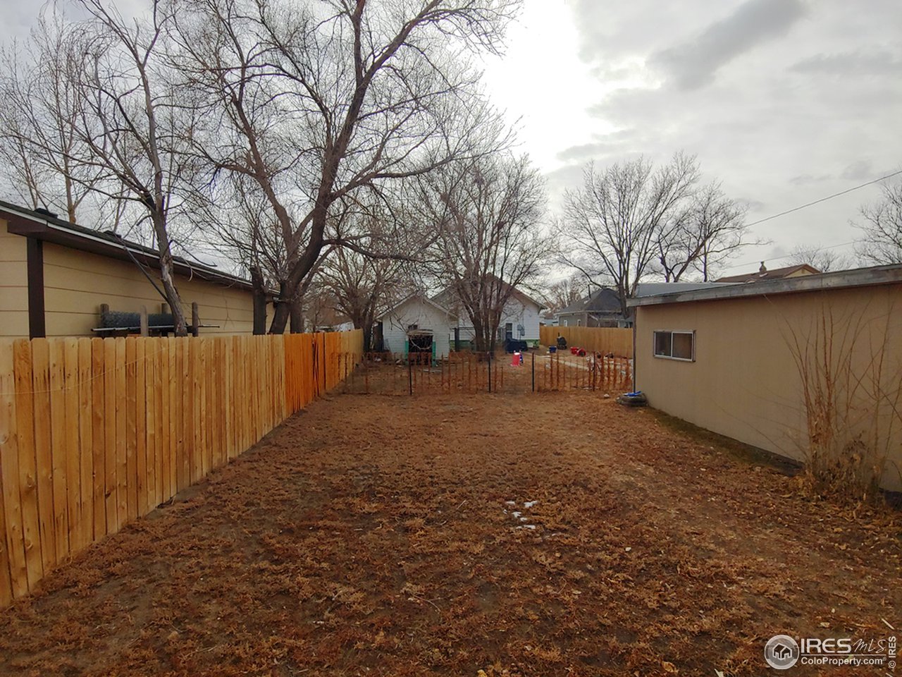 324 Platte Street Sterling, CO 80751 - Photo 16 of 18 a view of a yard with large trees