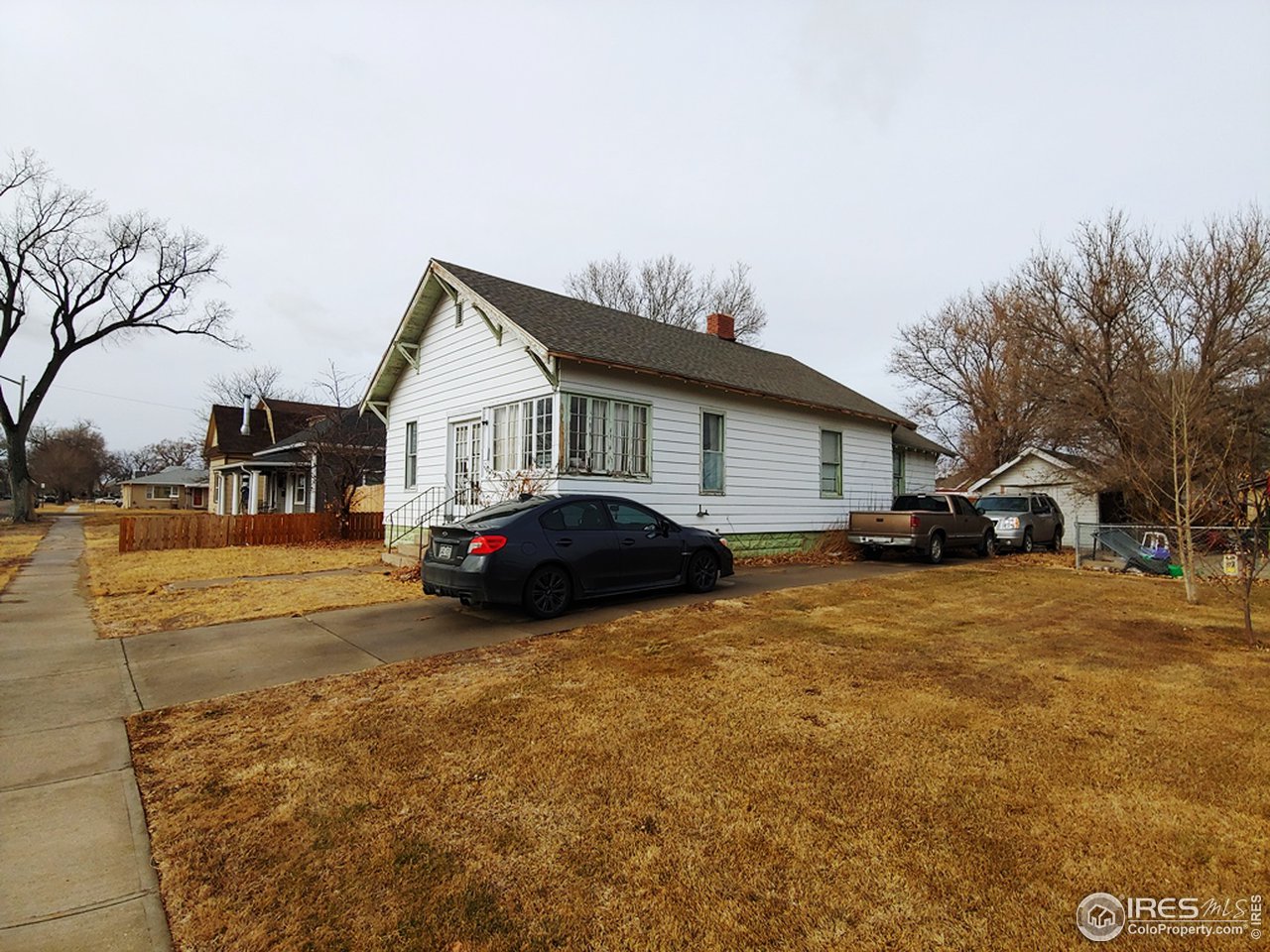 324 Platte Street Sterling, CO 80751 - Photo 2 of 18 a view of a house with a yard covered in snow