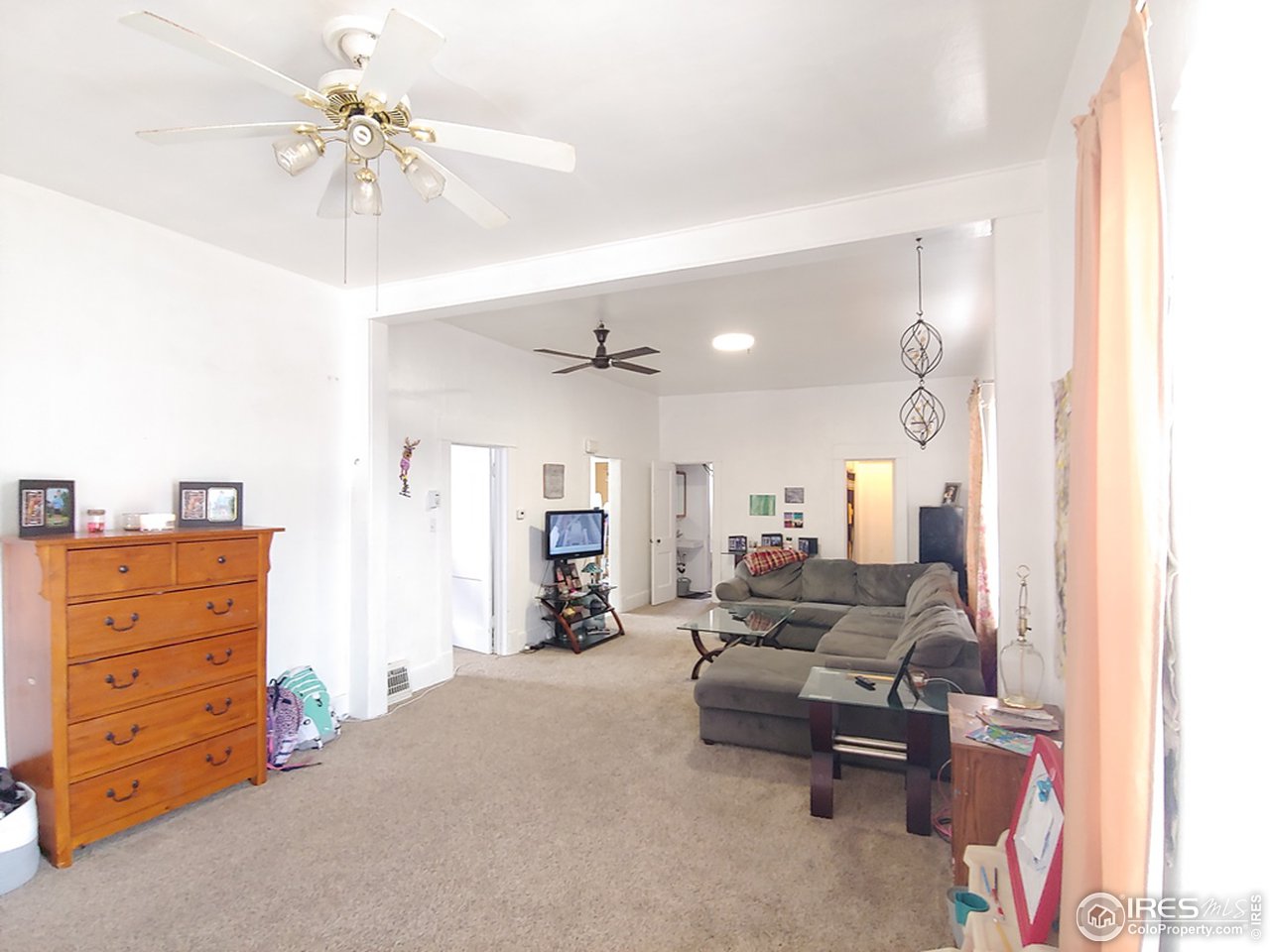 324 Platte Street Sterling, CO 80751 - Photo 5 of 18 a living room with furniture and a chandelier