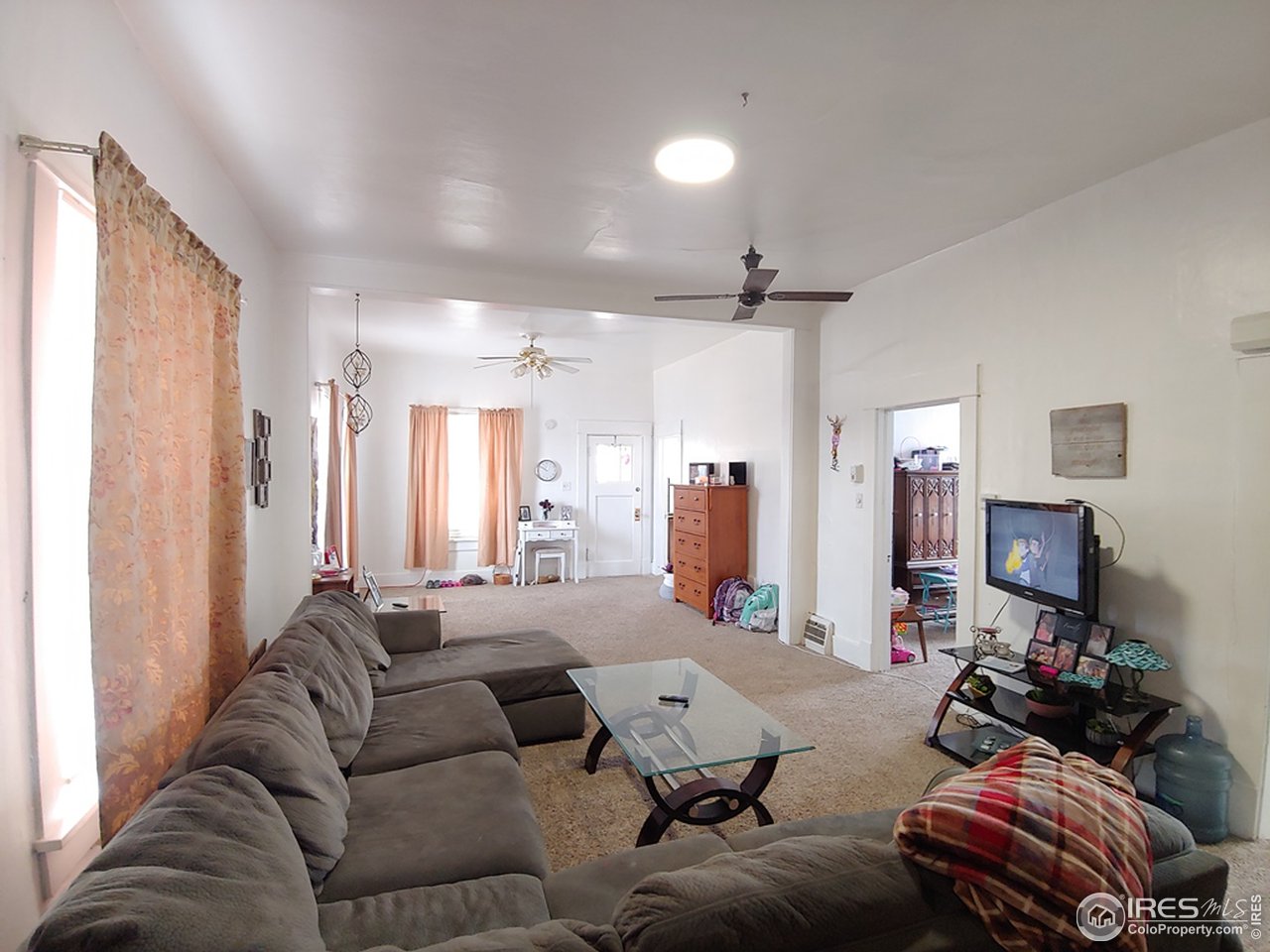 324 Platte Street Sterling, CO 80751 - Photo 7 of 18 a living room with furniture and a flat screen tv