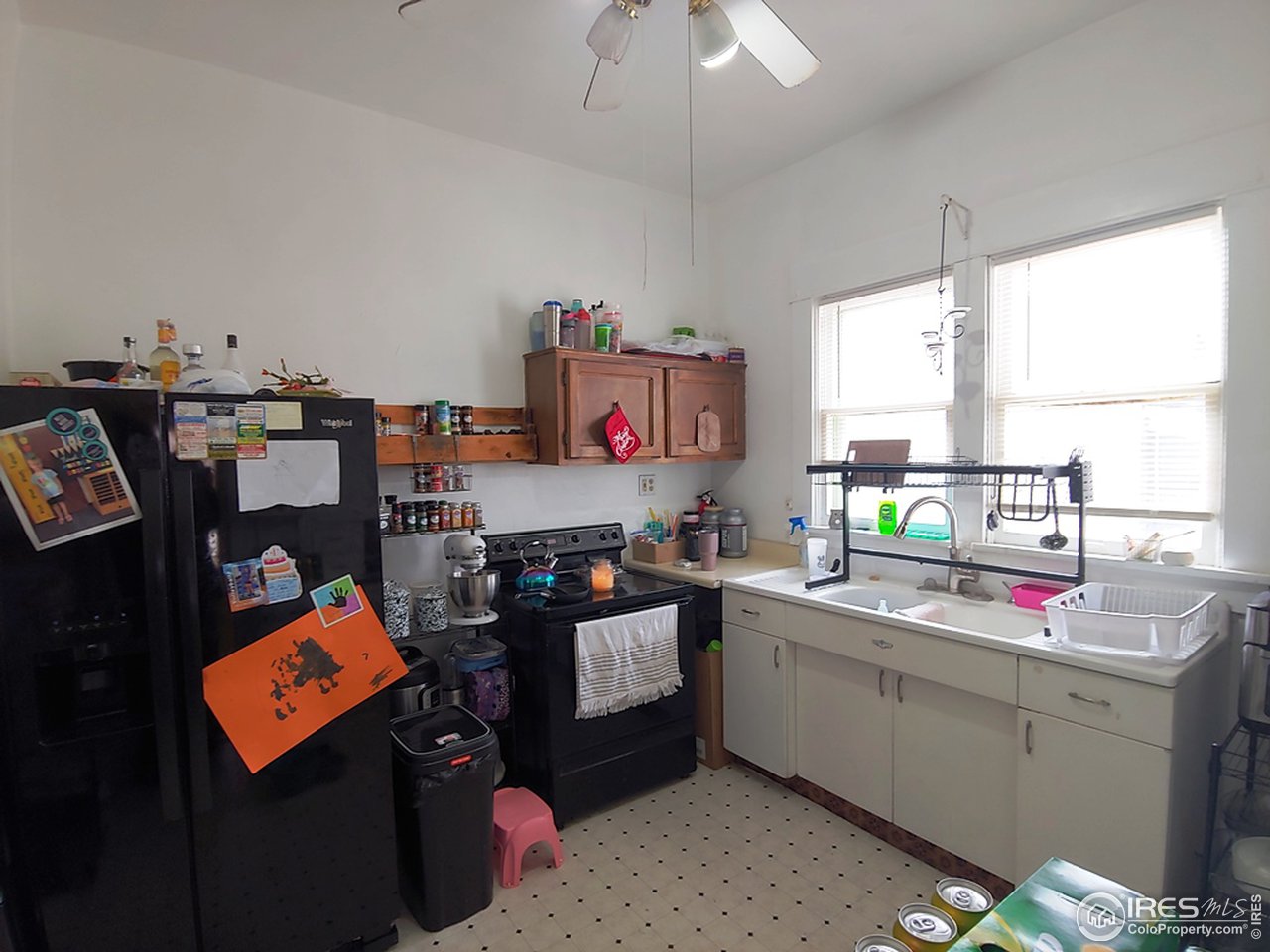 324 Platte Street Sterling, CO 80751 - Photo 9 of 18 a kitchen with kitchen island appliances cabinets and a window