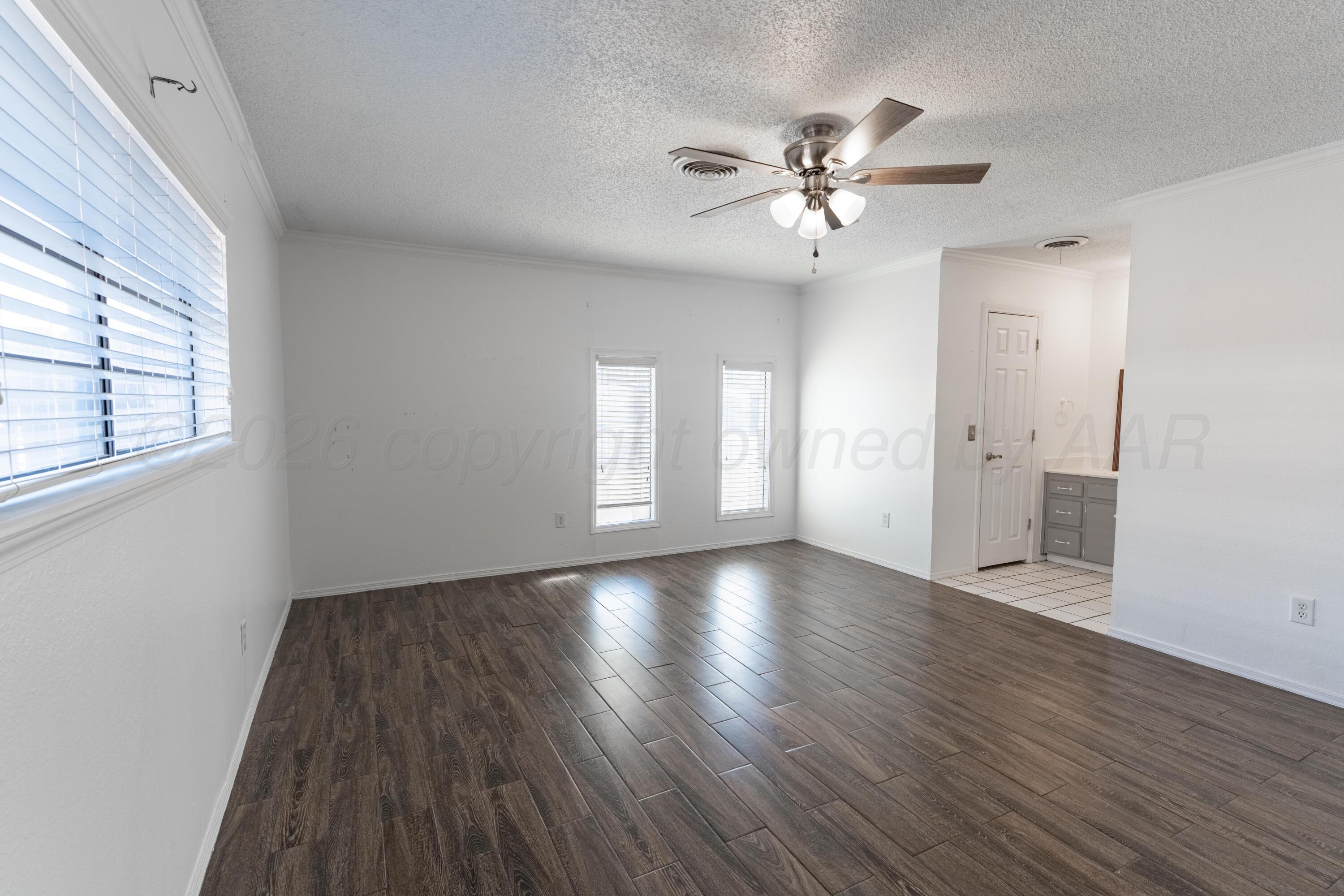 2907 Mable Drive Canyon, TX 79015 - Photo 11 of 19 a view of an empty room with wooden floor and a window