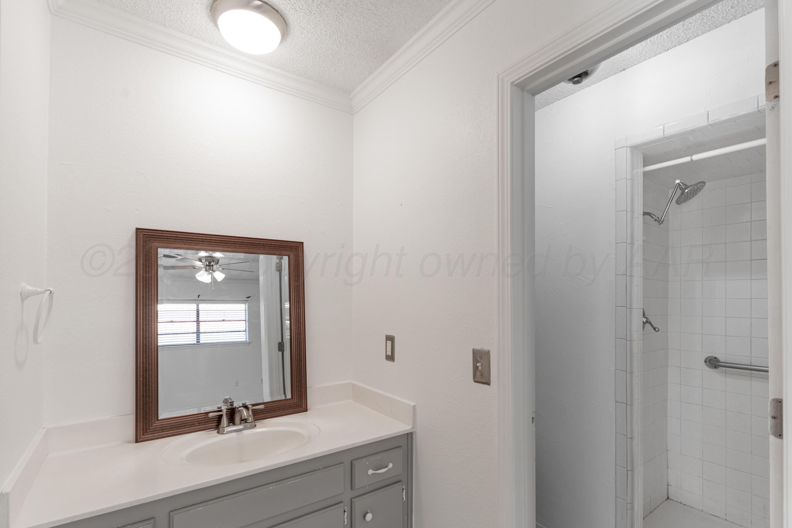 2907 Mable Drive Canyon, TX 79015 - Photo 12 of 19 a bathroom with a window sink and mirror