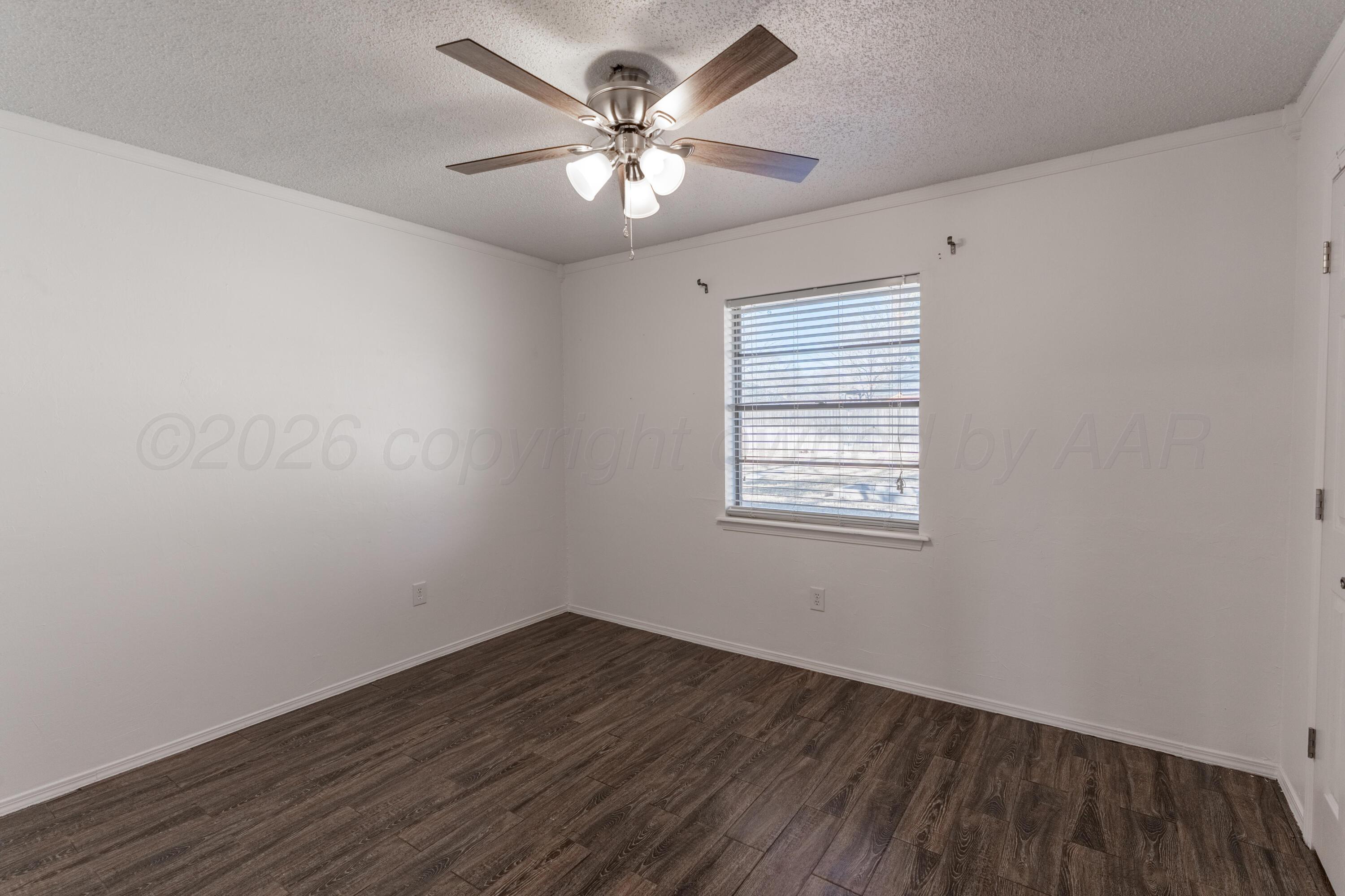 2907 Mable Drive Canyon, TX 79015 - Photo 14 of 19 wooden floor in an empty room with a window