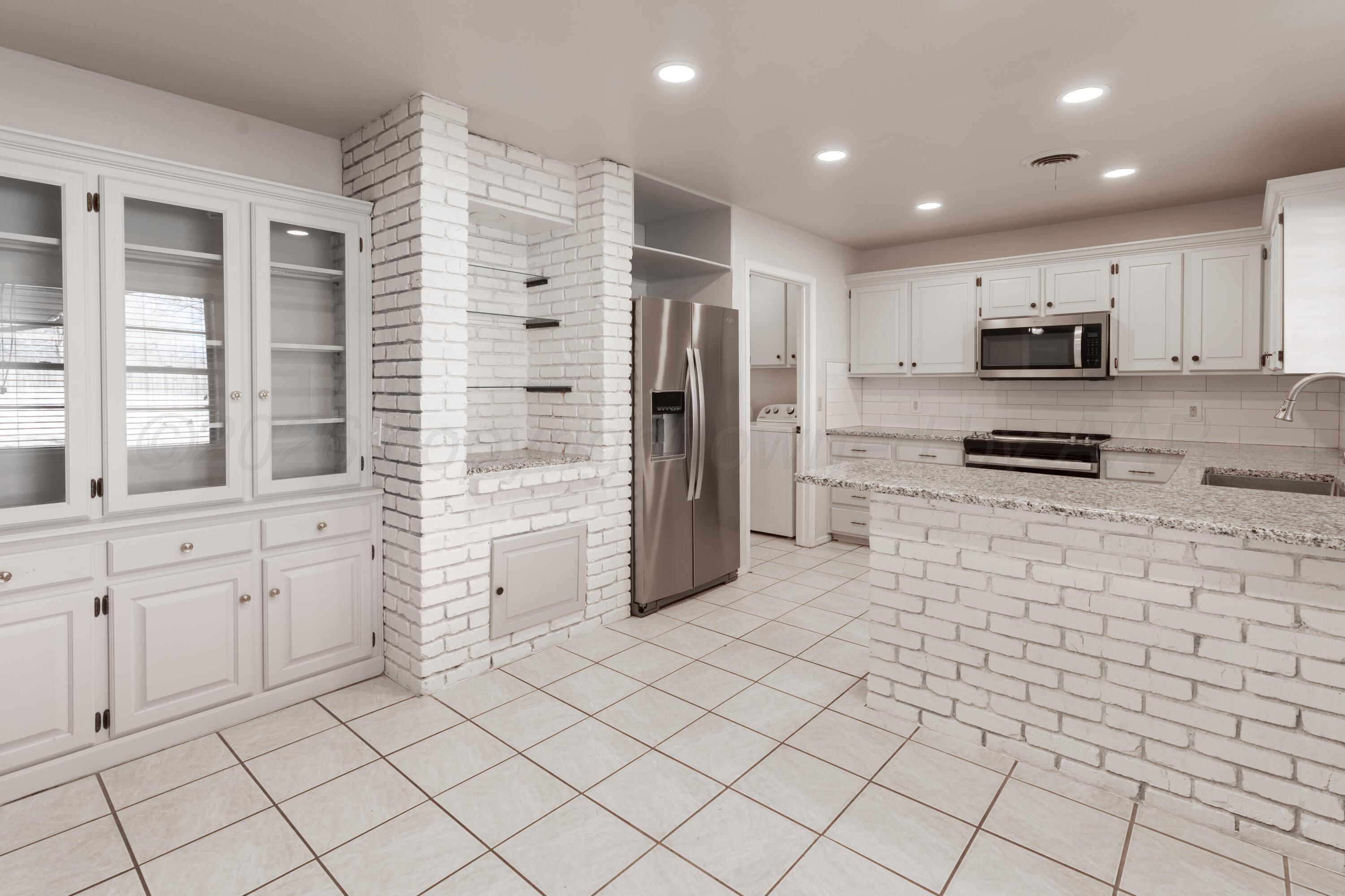 2907 Mable Drive Canyon, TX 79015 - Photo 5 of 19 a kitchen with white cabinets and refrigerator