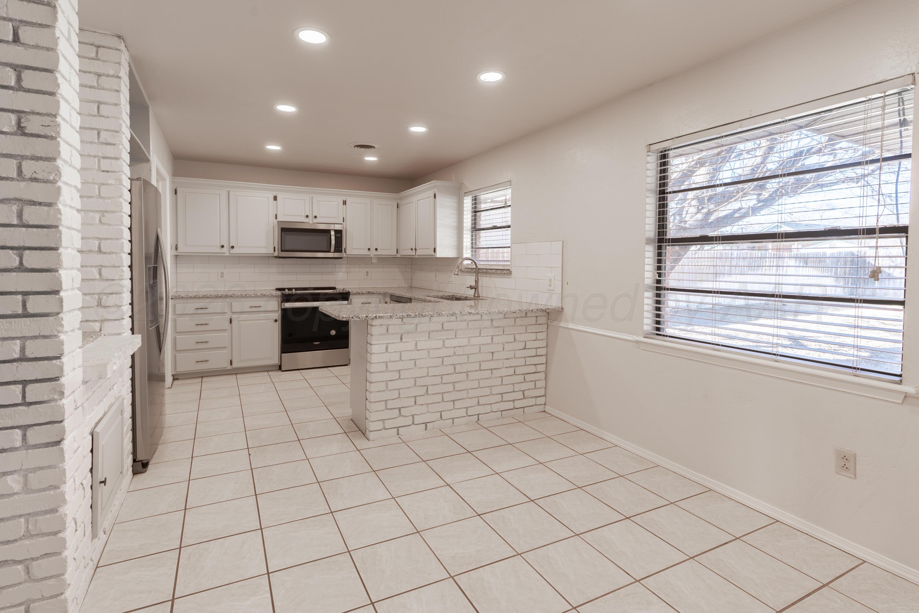 2907 Mable Drive Canyon, TX 79015 - Photo 6 of 19 a kitchen with stainless steel appliances cabinets a sink and a window