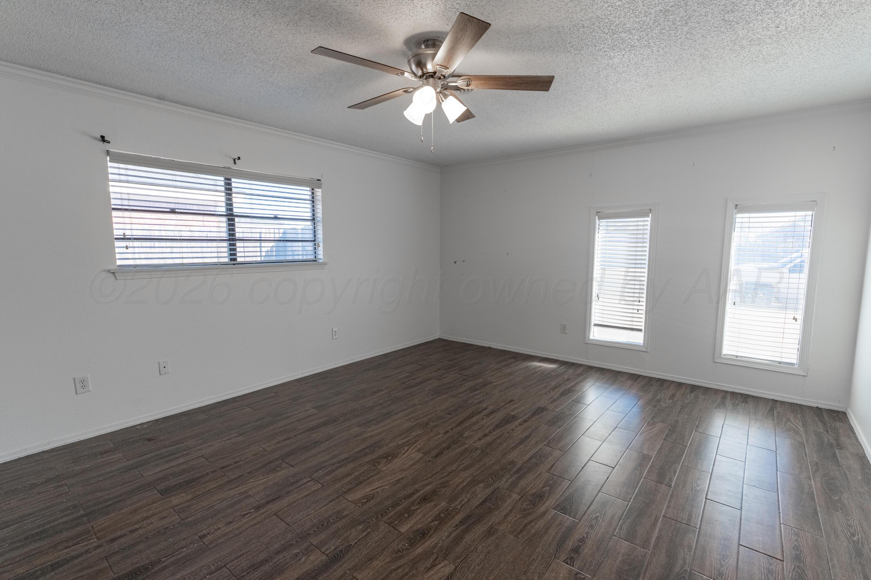 2907 Mable Drive Canyon, TX 79015 - Photo 9 of 19 a view of an empty room with wooden floor and a window