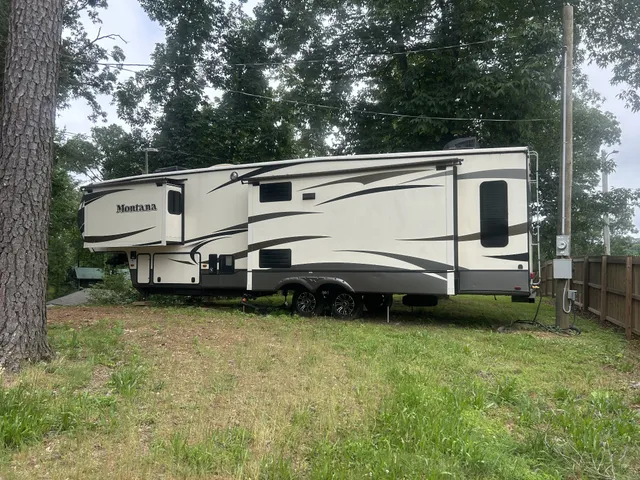 a view of a white house with a big yard and sitting area