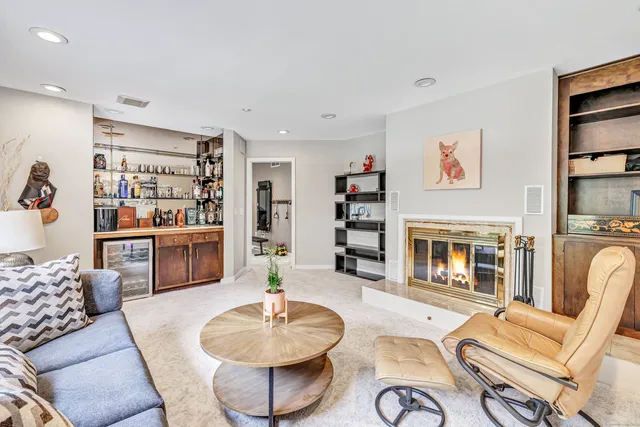 a living room with furniture kitchen view and a fireplace