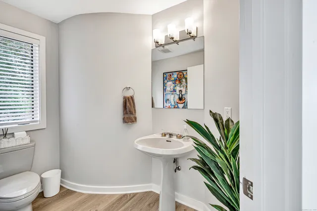 a bathroom with a sink toilet and a mirror