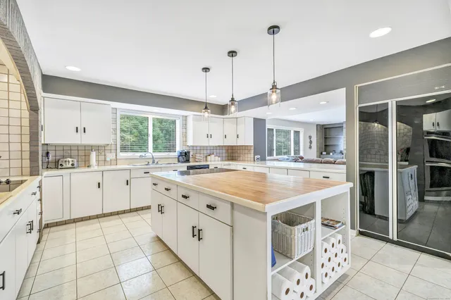a kitchen with a stove sink and cabinets