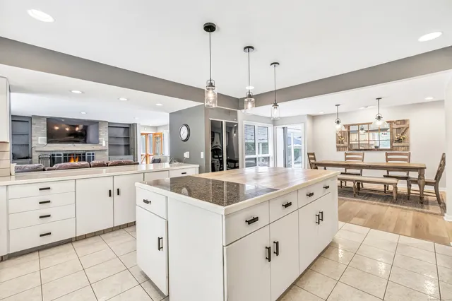 a large white kitchen with cabinets