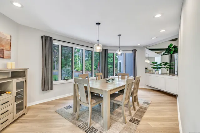a view of a dining room with furniture window and wooden floor