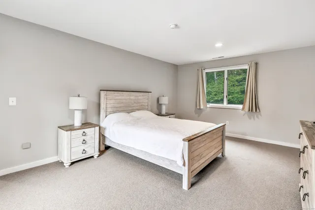 a bedroom with a bed and a window