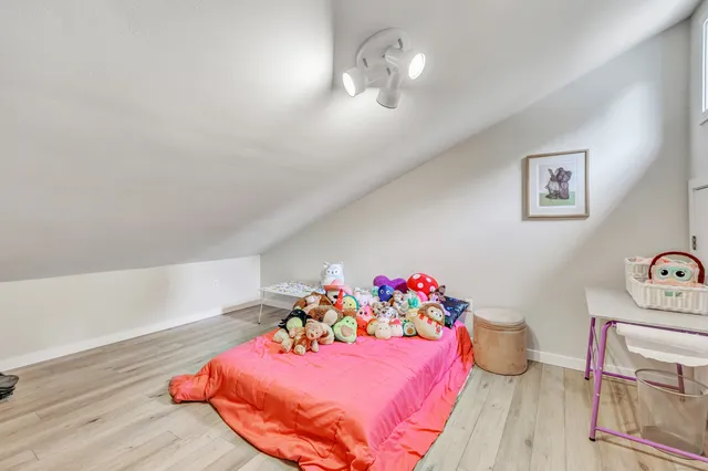 a bedroom with furniture and a wooden floor