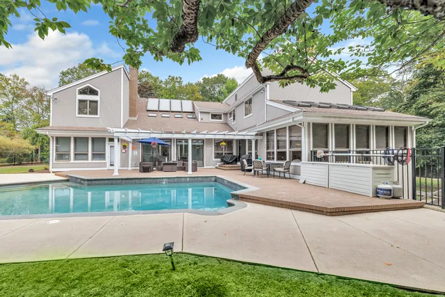 a front view of a house with a yard table and chairs