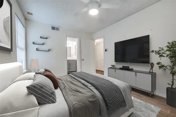 a hotel room with a television and a bed