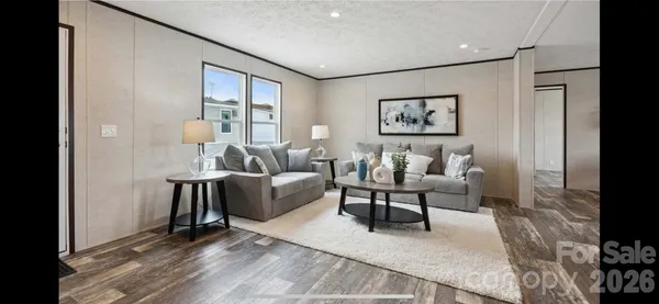 a living room with furniture and a floor to ceiling window