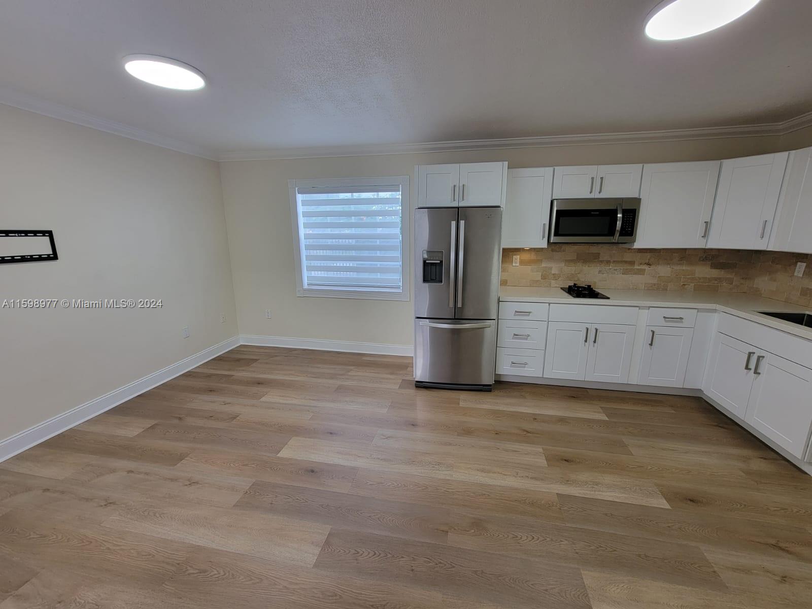 30701 Southwest 150th Avenue, Unit C Homestead, FL 33033 - Photo 14 of 30 an empty room with kitchen view and a window
