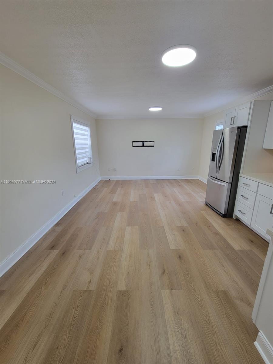 30701 Southwest 150th Avenue, Unit C Homestead, FL 33033 - Photo 16 of 30 a view of empty room with wooden floor and fan