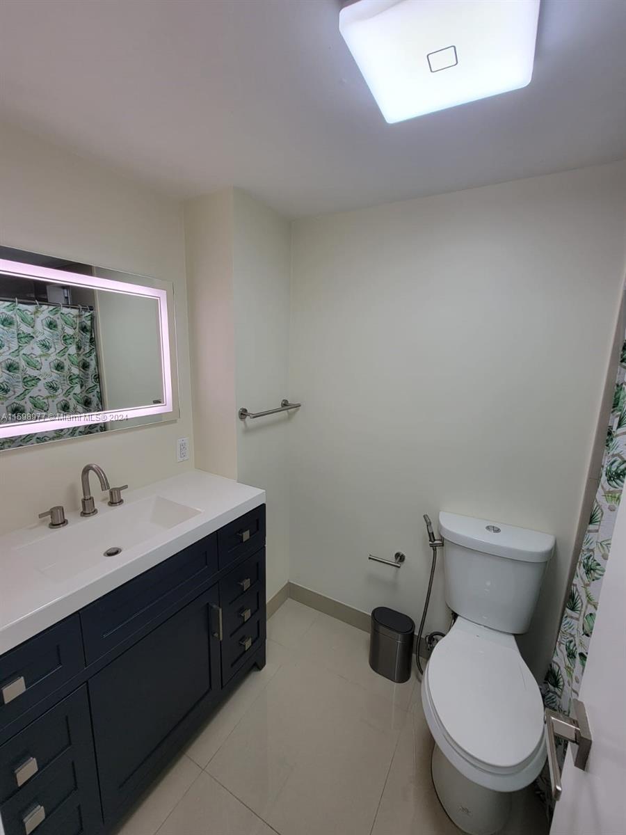 30701 Southwest 150th Avenue, Unit C Homestead, FL 33033 - Photo 24 of 30 a bathroom with a toilet sink and mirror
