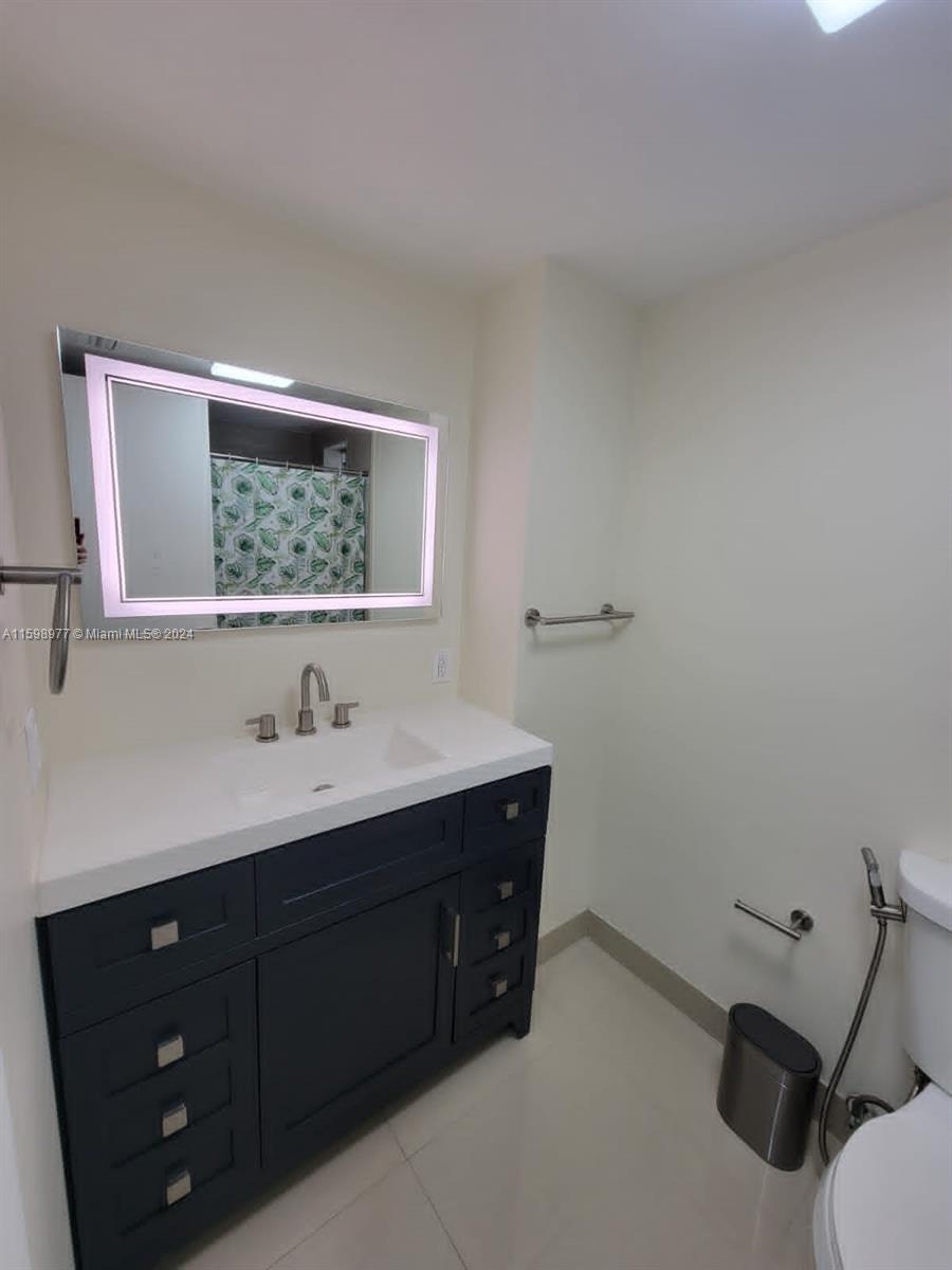 30701 Southwest 150th Avenue, Unit C Homestead, FL 33033 - Photo 25 of 30 a bathroom with a toilet sink and mirror