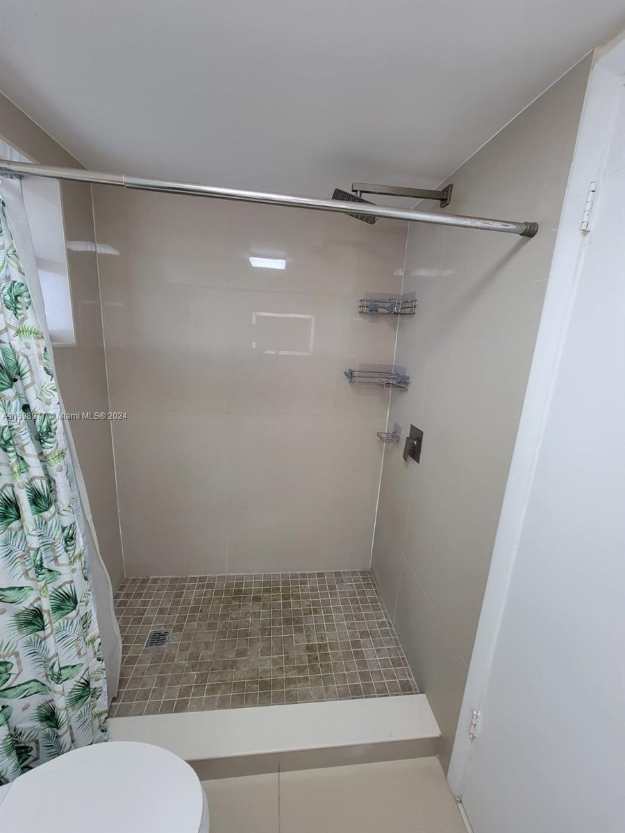 30701 Southwest 150th Avenue, Unit C Homestead, FL 33033 - Photo 27 of 30 a bathroom with a shower and a toilet