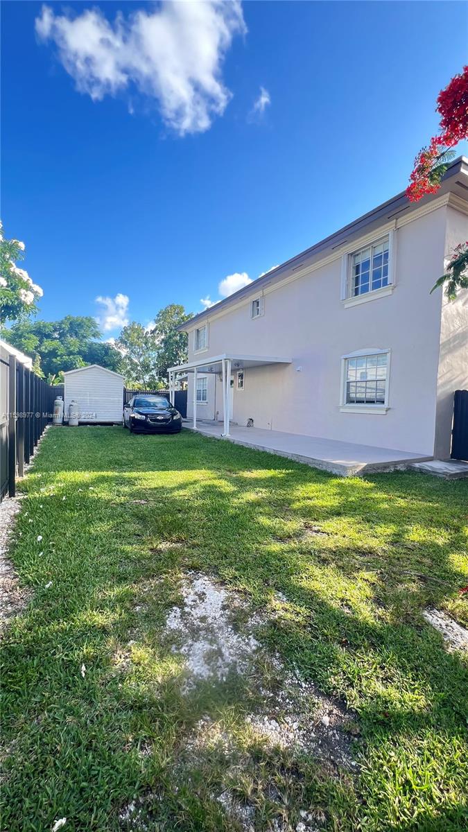30701 Southwest 150th Avenue, Unit C Homestead, FL 33033 - Photo 3 of 30 a view of a yard with a house in the background