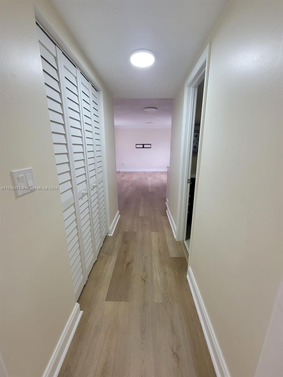 30701 Southwest 150th Avenue, Unit C Homestead, FL 33033 - Photo 10 of 30 a view of gallery with wooden floor