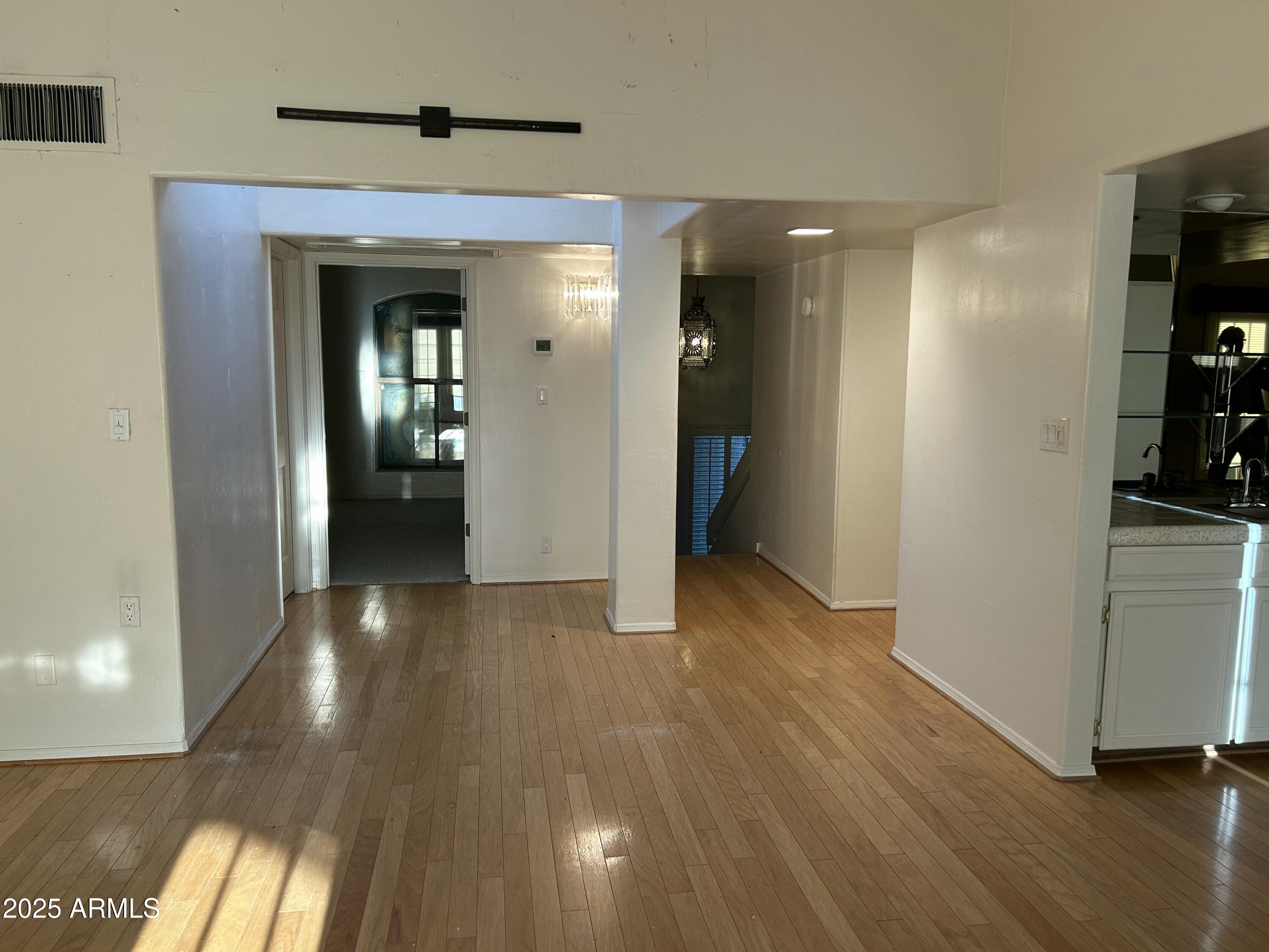 5736 North 25th Street Phoenix, AZ 85016 - Photo 12 of 24 a view of a hallway with wooden floor and closet