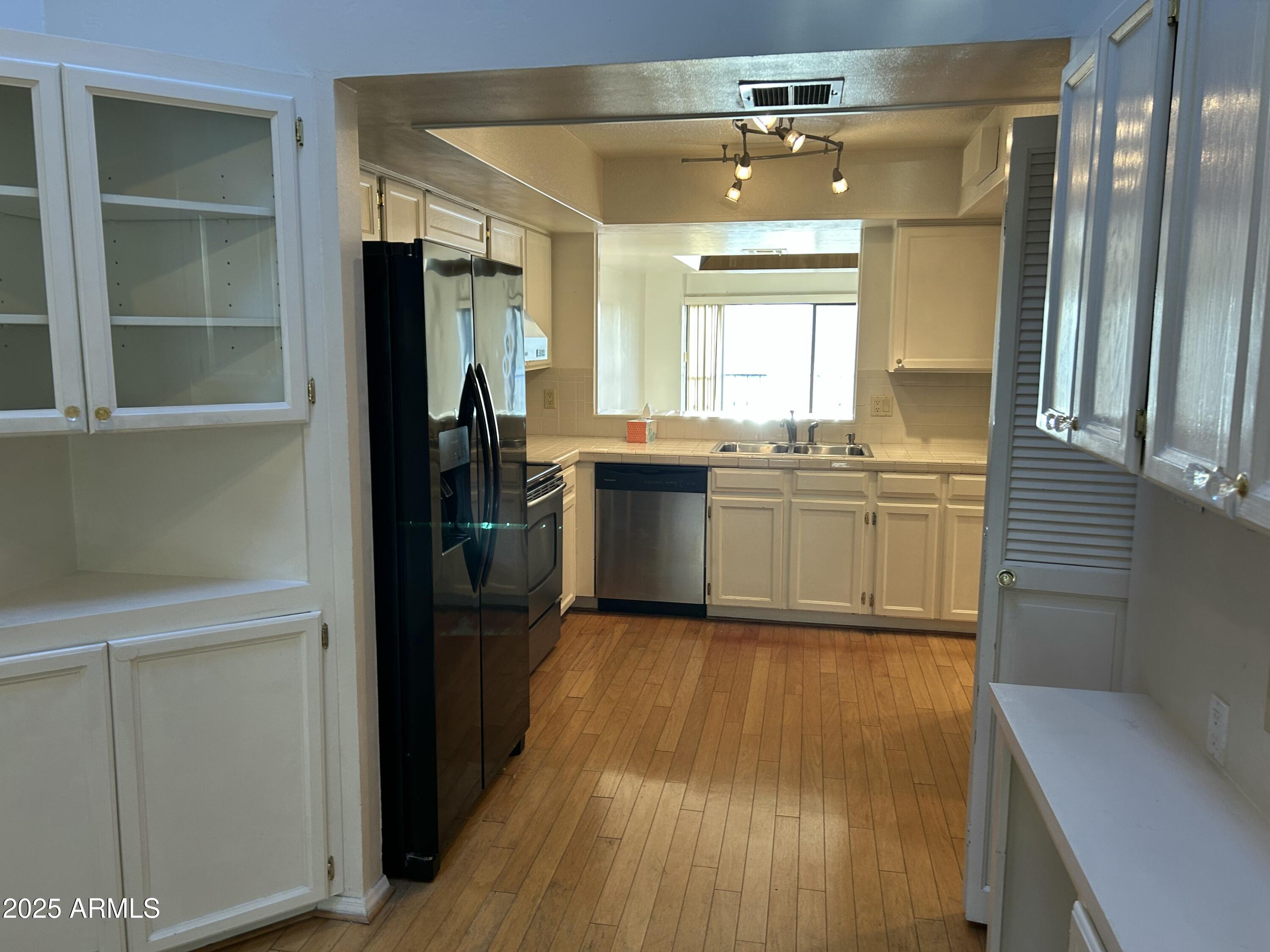 5736 North 25th Street Phoenix, AZ 85016 - Photo 9 of 24 a kitchen with stainless steel appliances granite countertop cabinets a sink and dishwasher