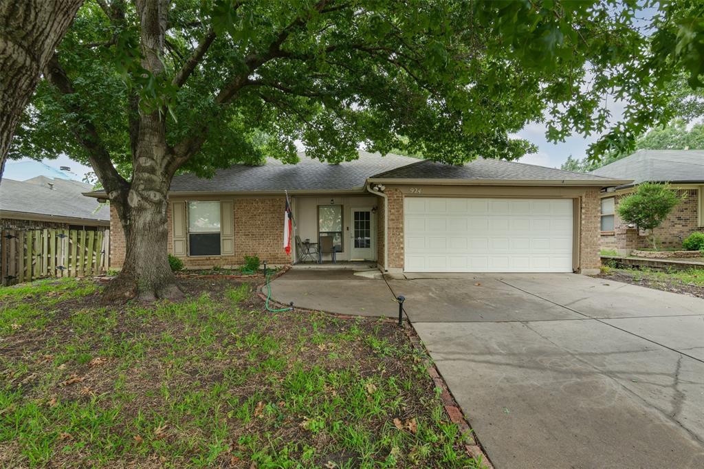 924 Thistle Ridge Lane Arlington, TX 76017 - Photo 1 of 1 a front view of a house with yard and green space