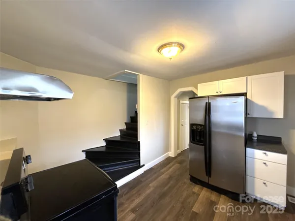 a kitchen with stainless steel appliances granite countertop a refrigerator and a stove