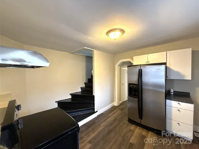 a kitchen with stainless steel appliances granite countertop a refrigerator and a stove