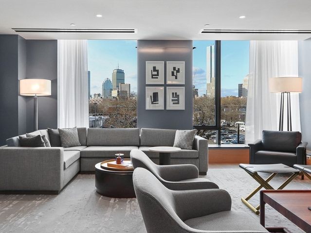a living room with furniture ceiling fan and a window