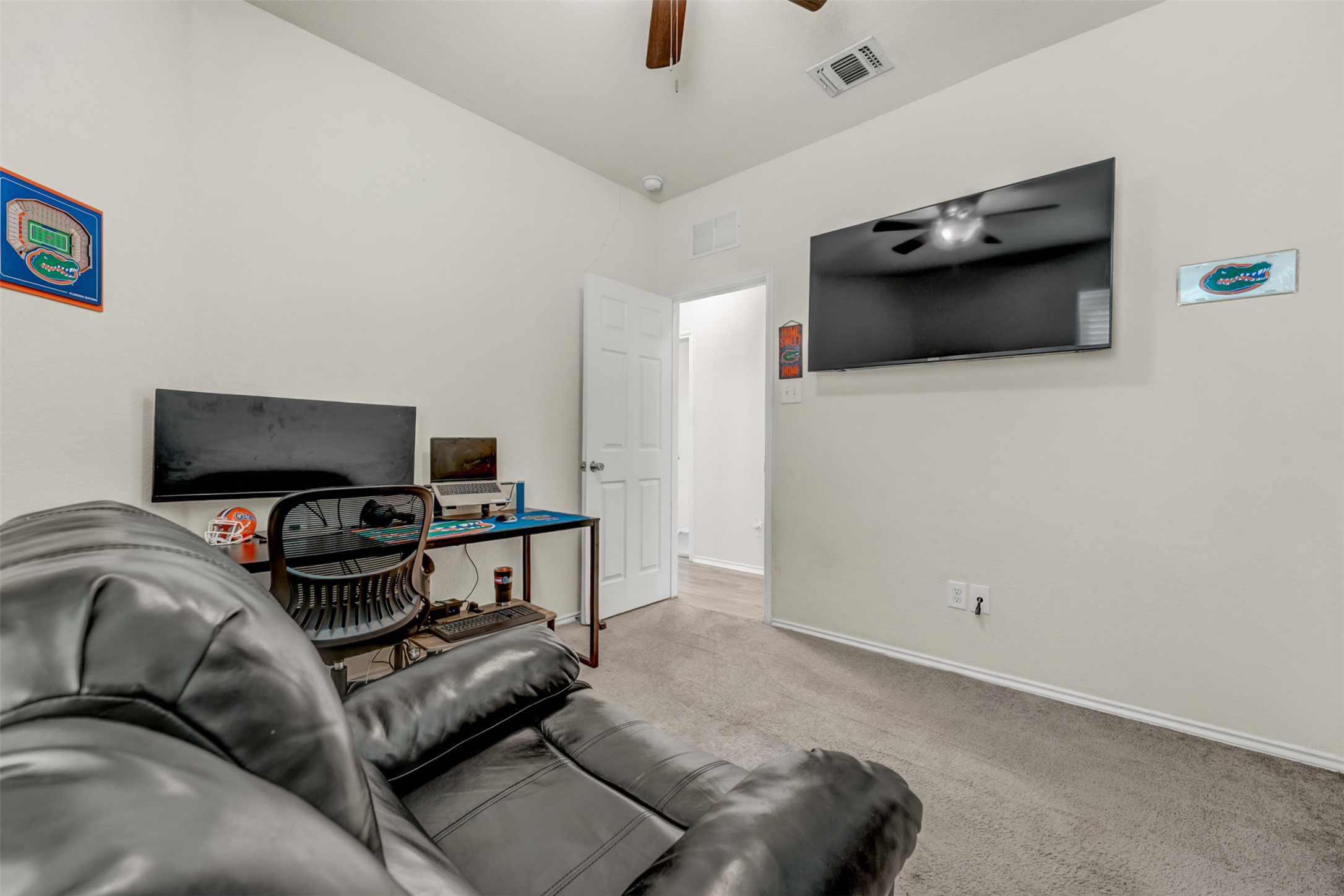 213 Ibis Falls Loop Jarrell, TX 76537 - Photo 24 of 37 A well-lit room featuring carpeted flooring and a modern ceiling fan for comfort.
