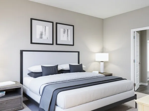 a bedroom with a bed a mirror on dresser and a window