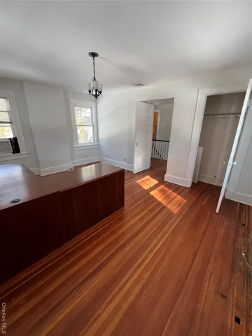a view of a room with wooden floor and staircase