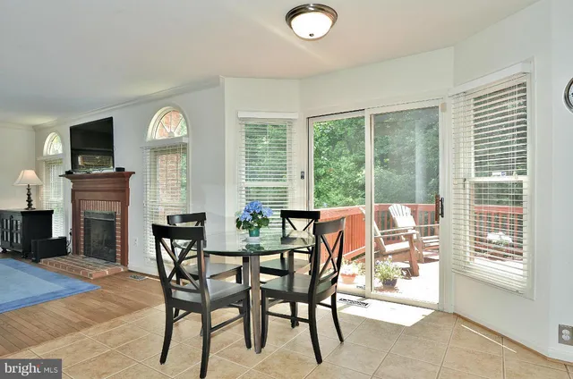 a dining room with furniture and a large window