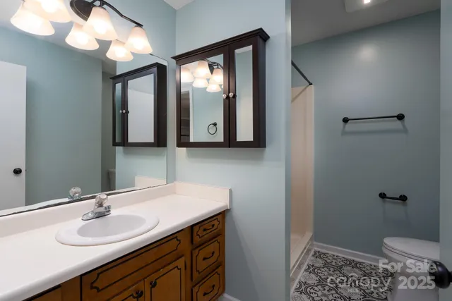 a bathroom with a toilet sink and mirror