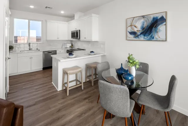 a view of a dining room with furniture and wooden floor