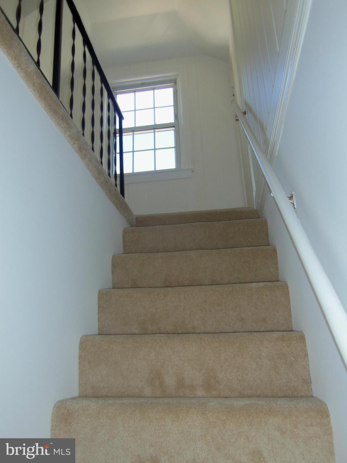 10148 Sutherland Road Silver Spring, MD 20901 - Photo 15 of 30 a view of staircase with white walls and windows