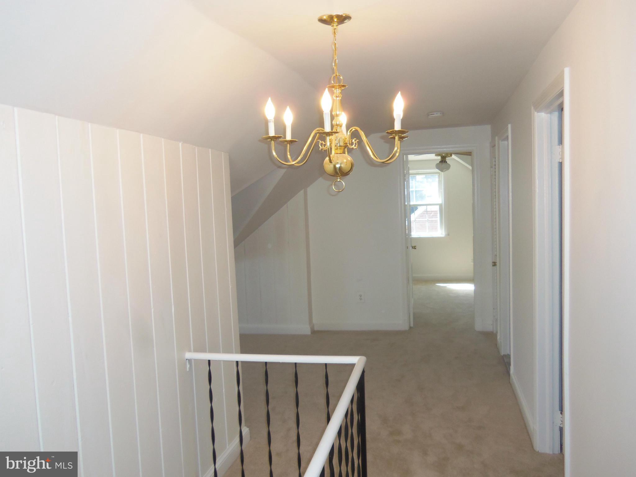 10148 Sutherland Road Silver Spring, MD 20901 - Photo 17 of 30 a view of a chandelier fan and wooden floor