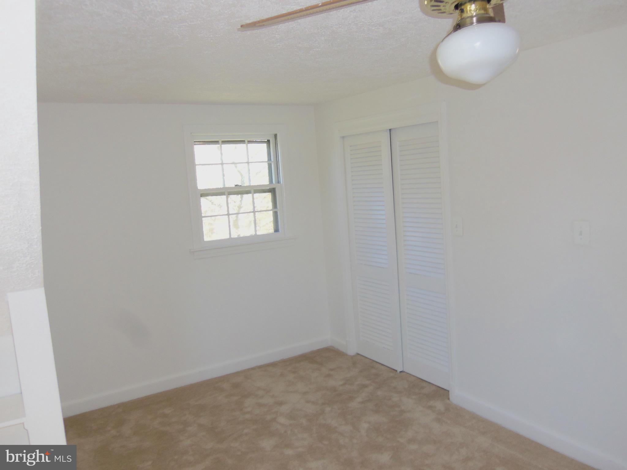 10148 Sutherland Road Silver Spring, MD 20901 - Photo 23 of 30 an empty room with wooden floor and windows