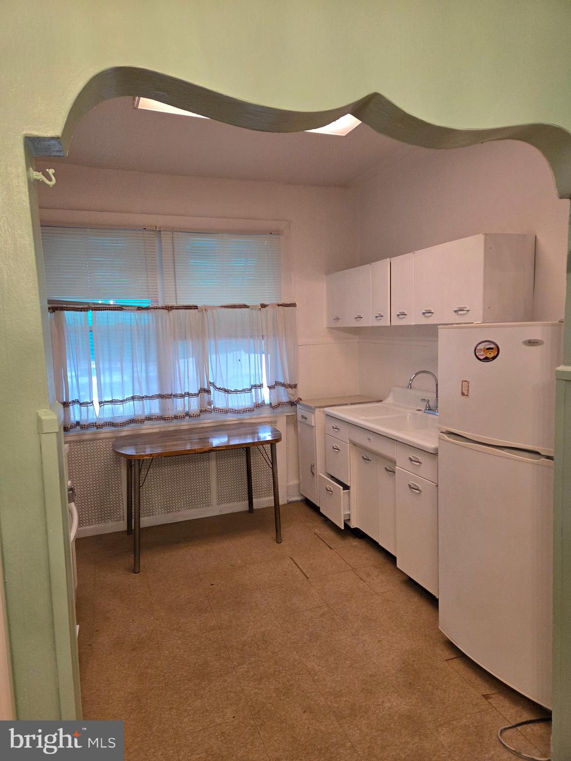 2014 South 68th Street Philadelphia, PA 19142 - Photo 4 of 9 a kitchen with white cabinets and white appliances